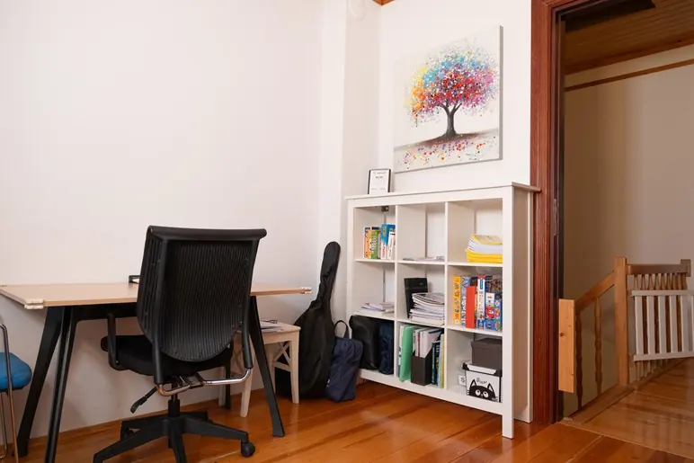 Masa, ergonomik sandalye ve kitaplıklı değerlendirme odası